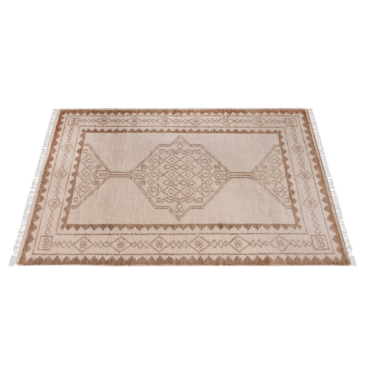 Gulab hand-knotted NZ wool rug with a blush medallion on an ivory field, in a bedroom
