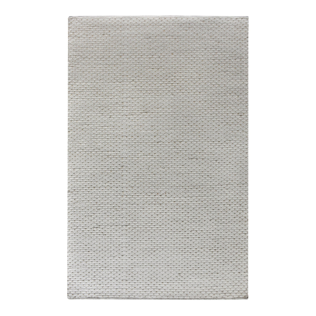 Kankar handwoven wool and jute rug in pale ivory-grey with a pebbled loop weave, in a bedroom