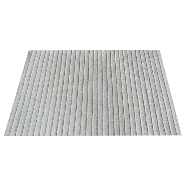Sopan handwoven New Zealand wool rug with broad ivory ridges, in a living room