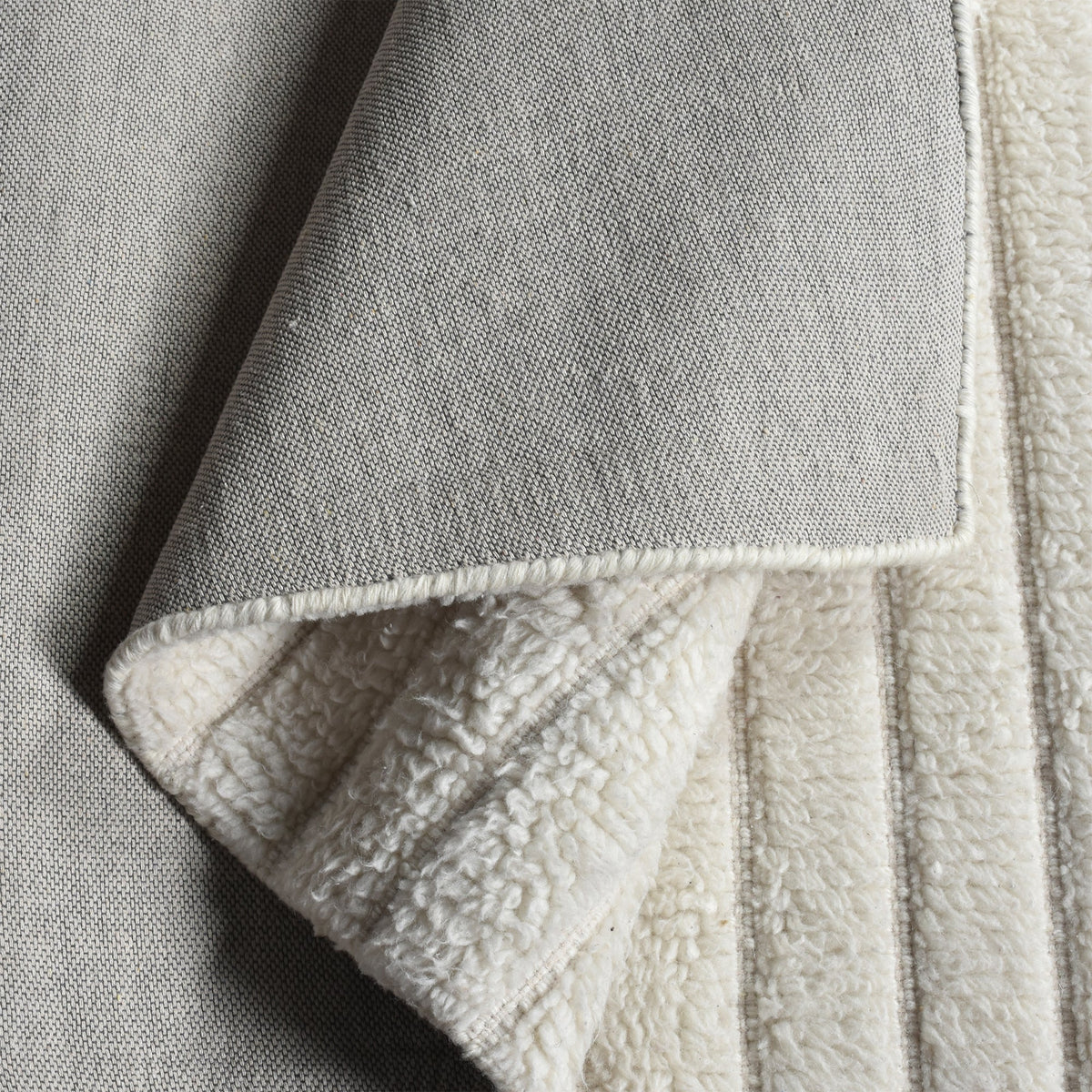 Sopan handwoven New Zealand wool rug with broad ivory ridges, in a living room