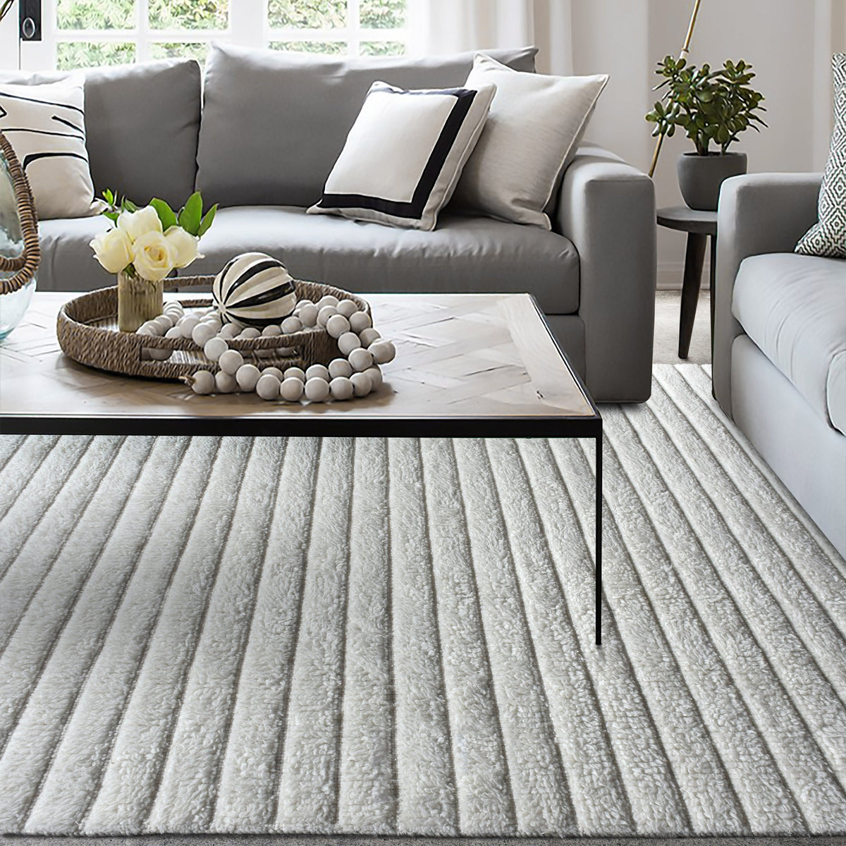 Sopan handwoven New Zealand wool rug with broad ivory ridges, in a living room
