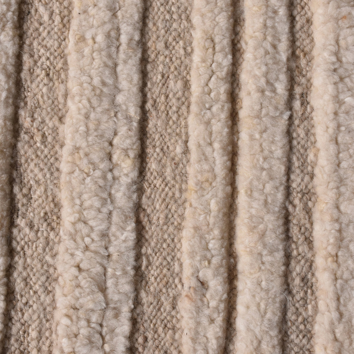 Pankti hand-knotted NZ wool rug in cream and oat with carved vertical stripes, in a dining room