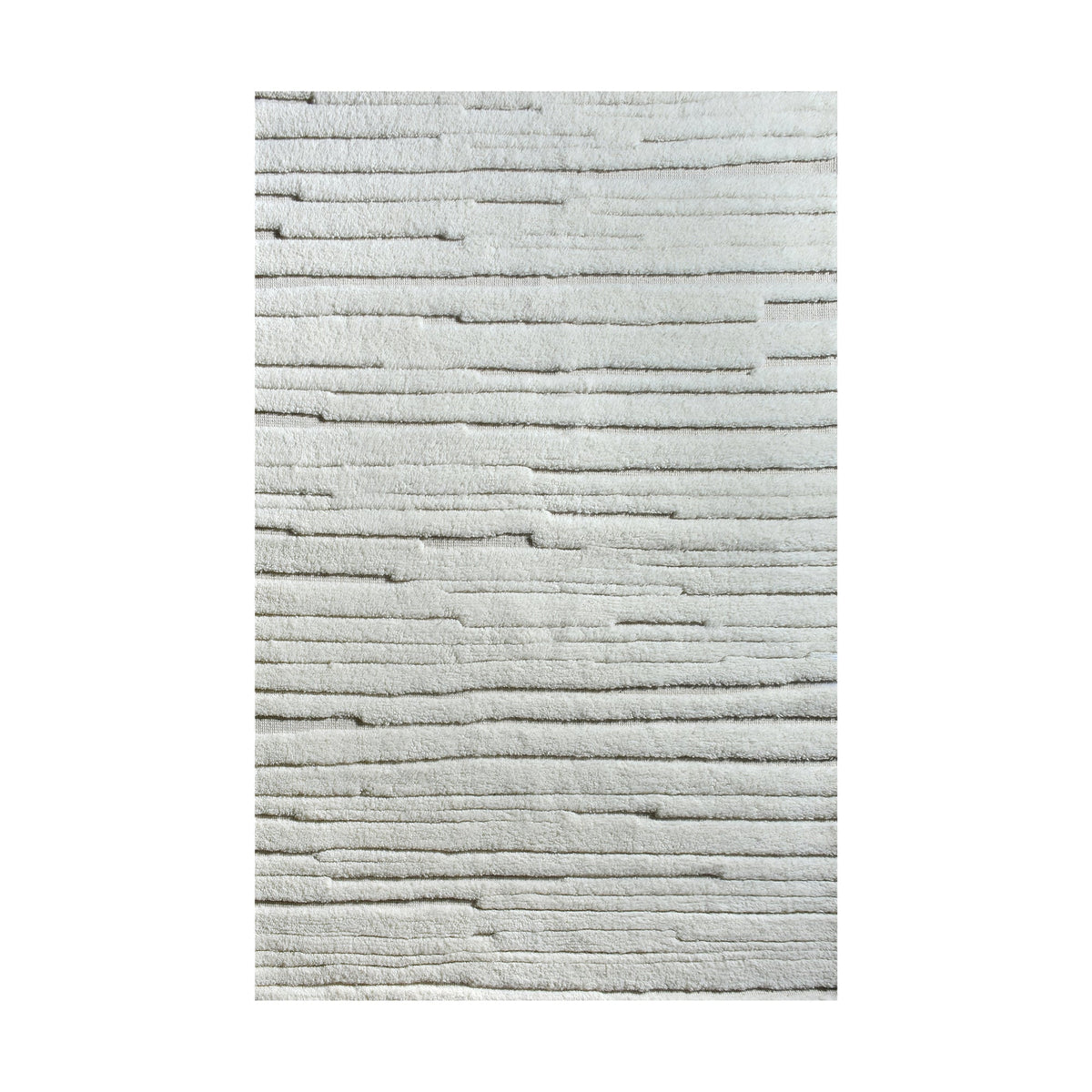 Bark handwoven ivory wool rug with carved vertical ridges, in a living room
