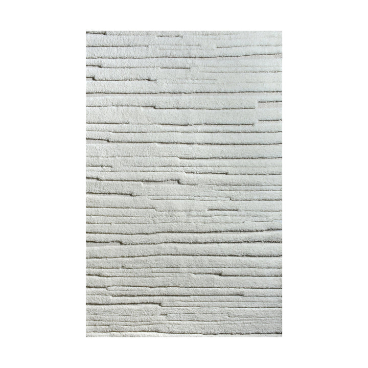 Bark handwoven ivory wool rug with carved vertical ridges, in a living room