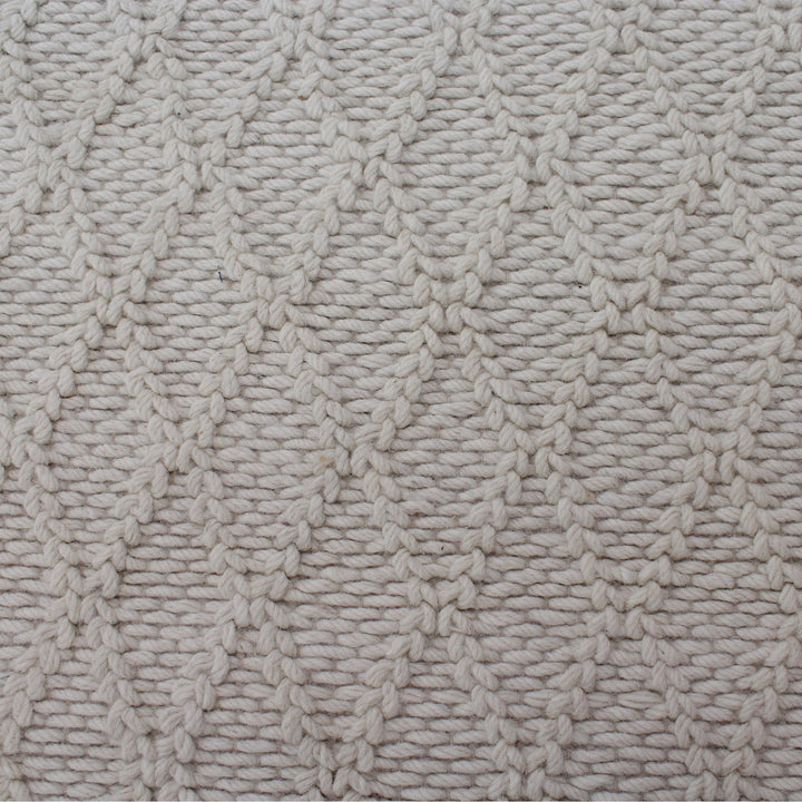 Jaal handwoven ivory wool rug with a raised cabled diamond lattice, in a living room