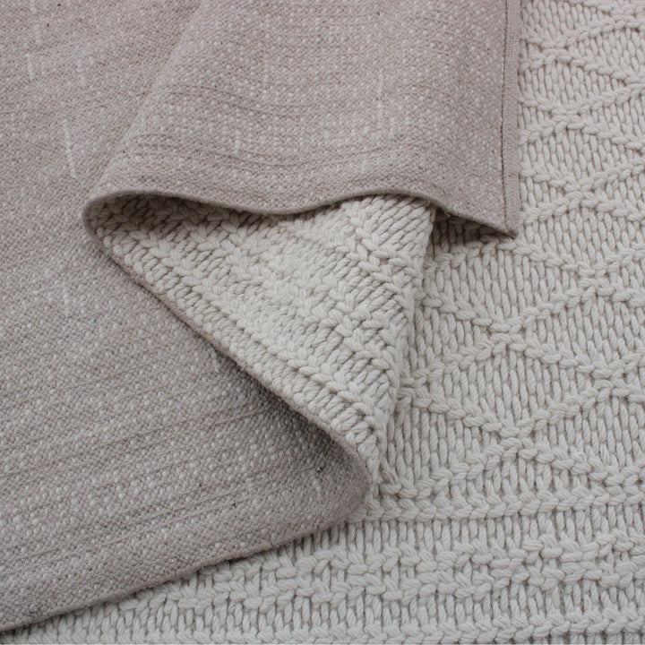 Jaal handwoven ivory wool rug with a raised cabled diamond lattice, in a living room