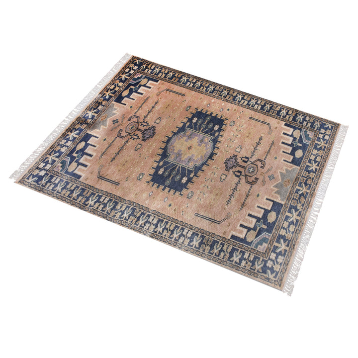 Darbar hand-knotted wool rug with rust and navy Anatolian medallions, in a living room