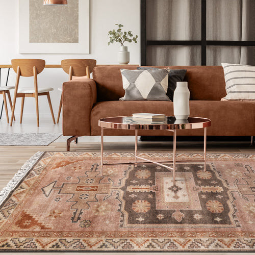 Matka hand-knotted wool rug with a faded terracotta Persian medallion, navy and brown, in a bedroom