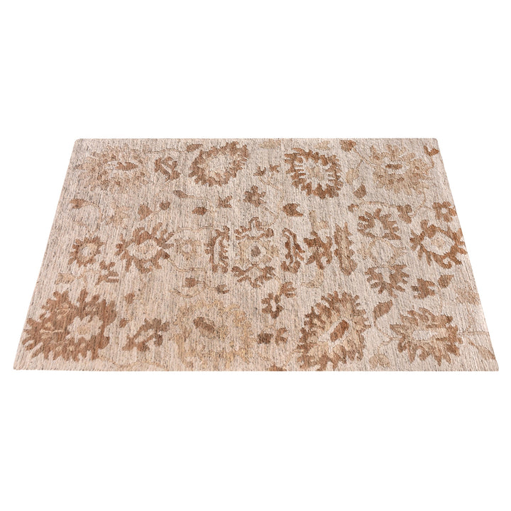 Peony hand-knotted ivory jute rug with faded terracotta florals, in a living room