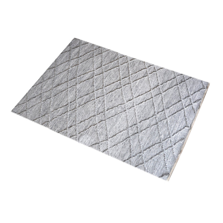 Razai handwoven recycled PET rug with a taupe diamond-quilted raised weave, on a patio