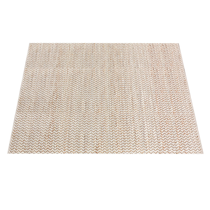 Chevron handwoven cream wool and jute rug with a herringbone chevron weave, in a living room