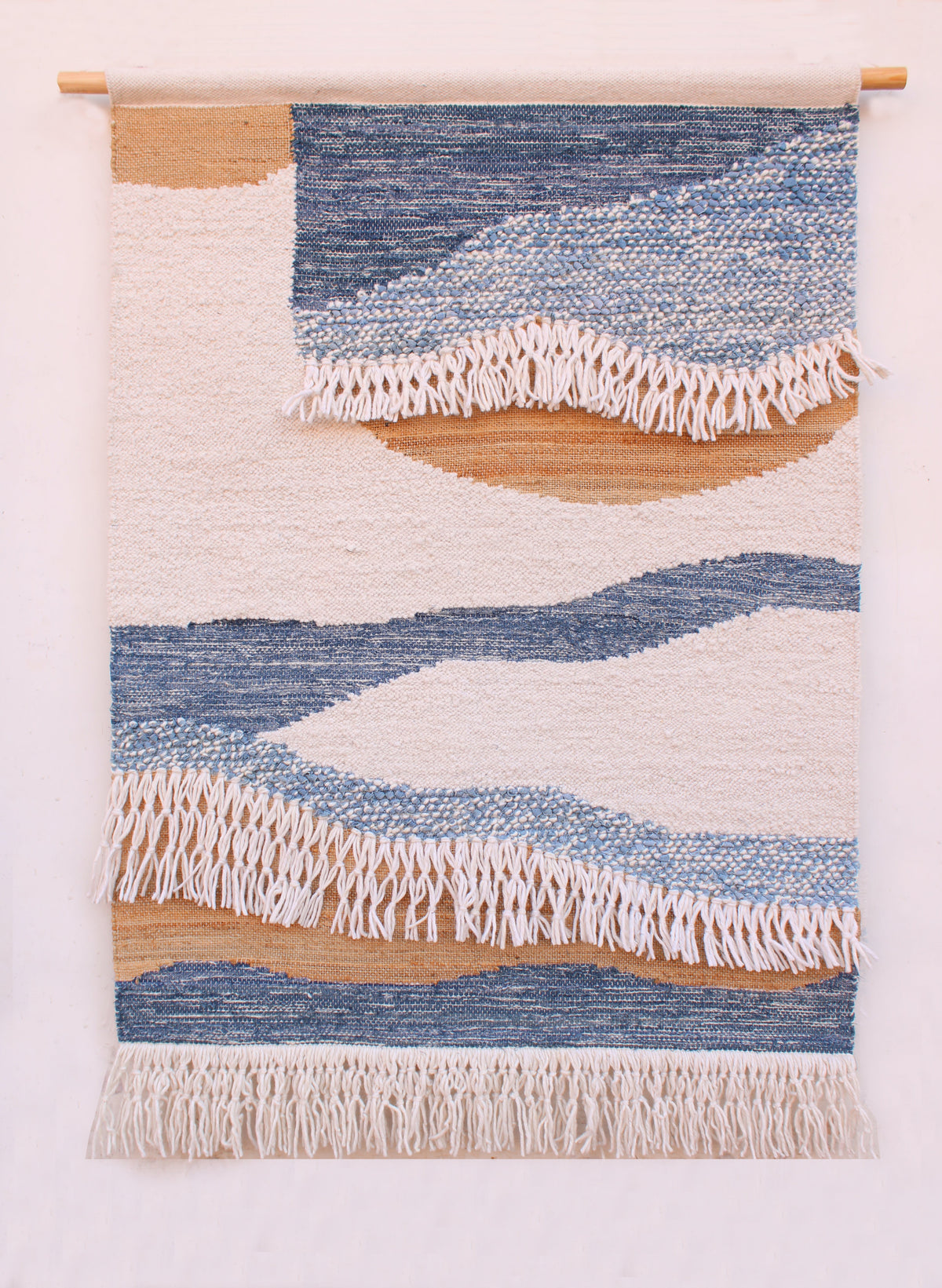 Littoral Handwoven Textile Wall Hanging — Blue and natural bands cross an ivory ground, with a softly fringed lower edge.