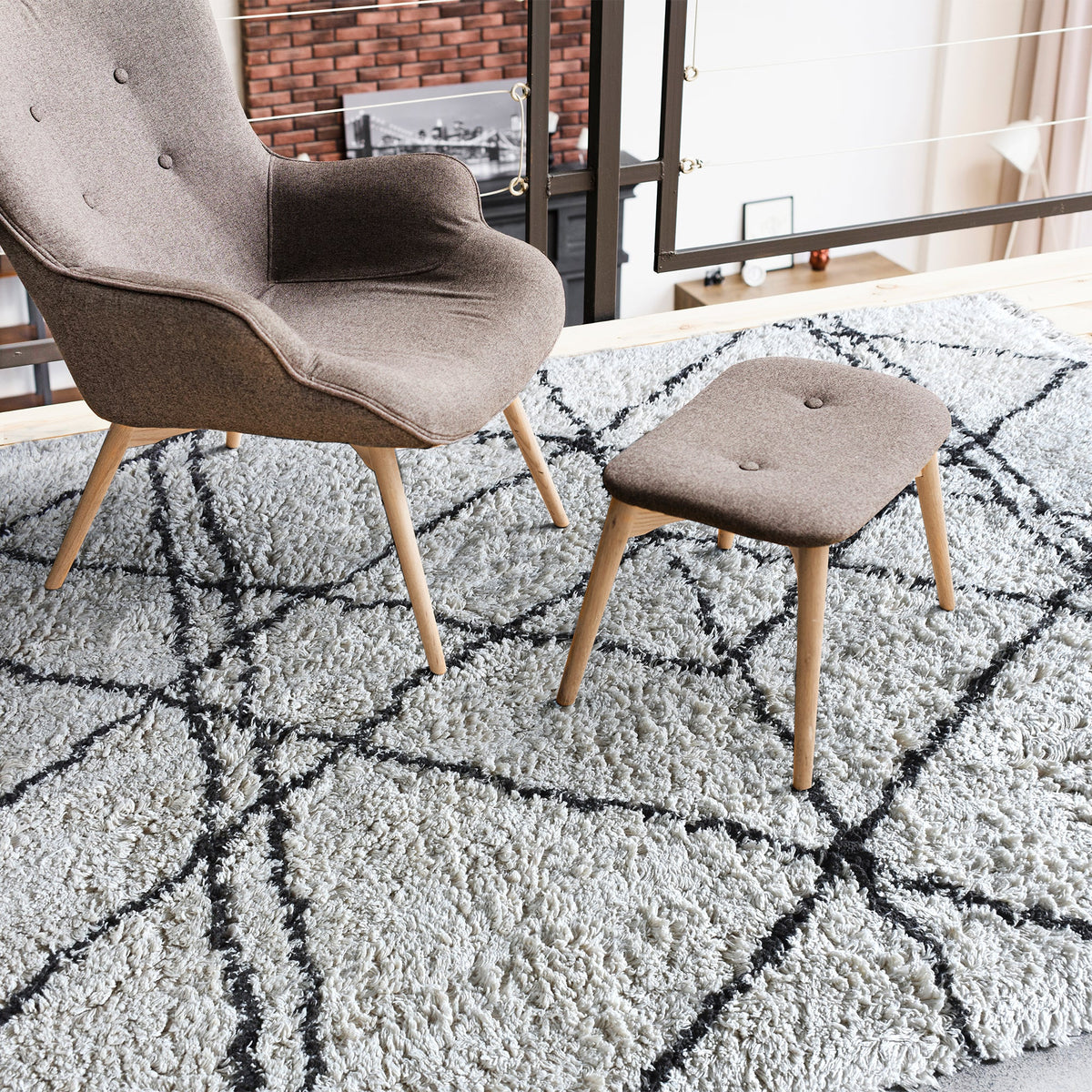 Lipi tufted cotton shag rug in ivory with a bold black lattice, in a bedroom