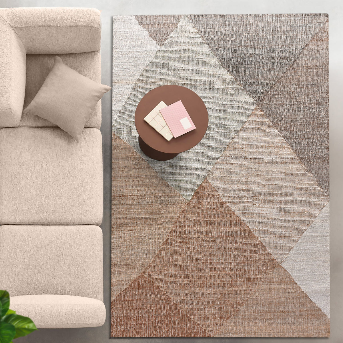 Patang handwoven jute flatweave rug with large blush, tan and grey diamonds, in a bedroom