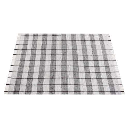 Gamcha handwoven recycled denim flatweave rug with a charcoal-grey and ivory buffalo check, in a living room