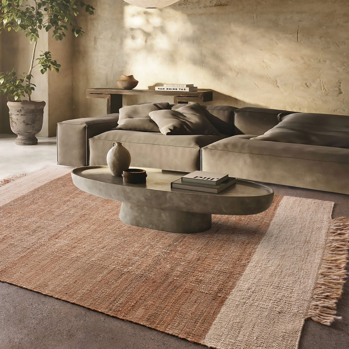 Sunbaked flatweave jute and wool rug in terracotta and blush colour blocks, in a living room