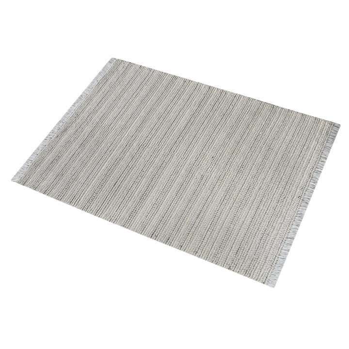 Kinara handwoven wool and jute rug in ivory and beige stripes, in a living room