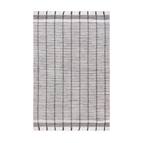 Awning handwoven denim and cotton rug with broad grey and ivory stripes, in a living room
