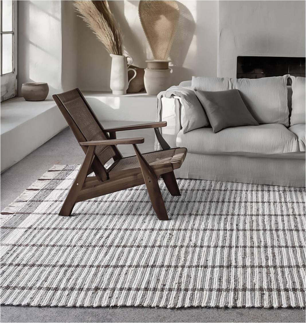 Awning handwoven denim and cotton rug with broad grey and ivory stripes, in a living room