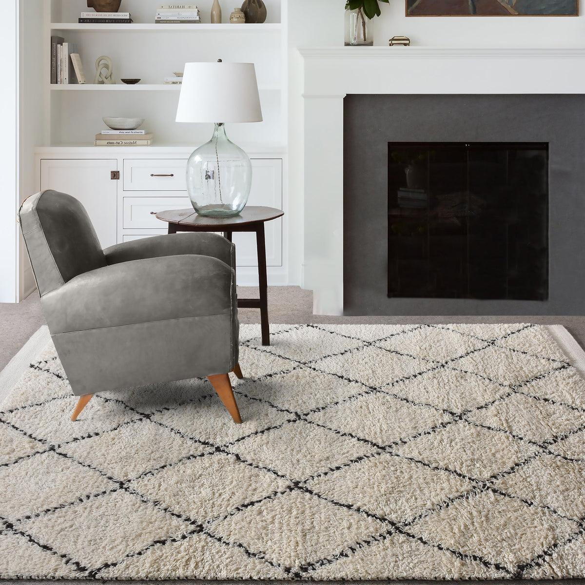 Syahi handwoven wool rug with a charcoal diamond lattice on ivory, in a study