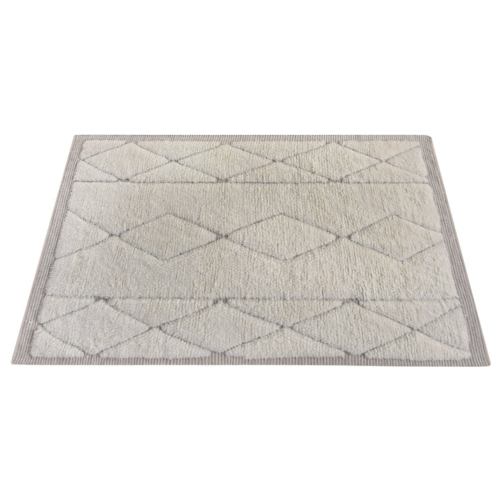 Ola handwoven New Zealand wool rug with an ivory Moroccan diamond lattice and grey, in a living room