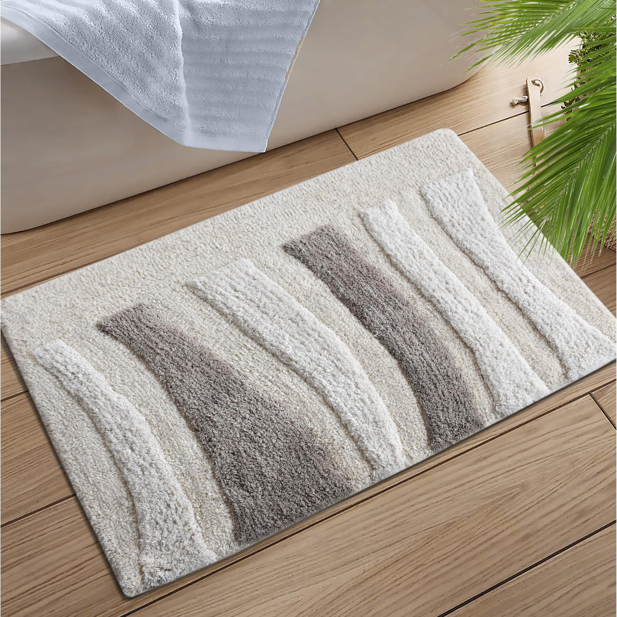 Silver Rill Cotton Bath Rug — Raised ivory and grey waves give this neutral bath rug movement and texture.