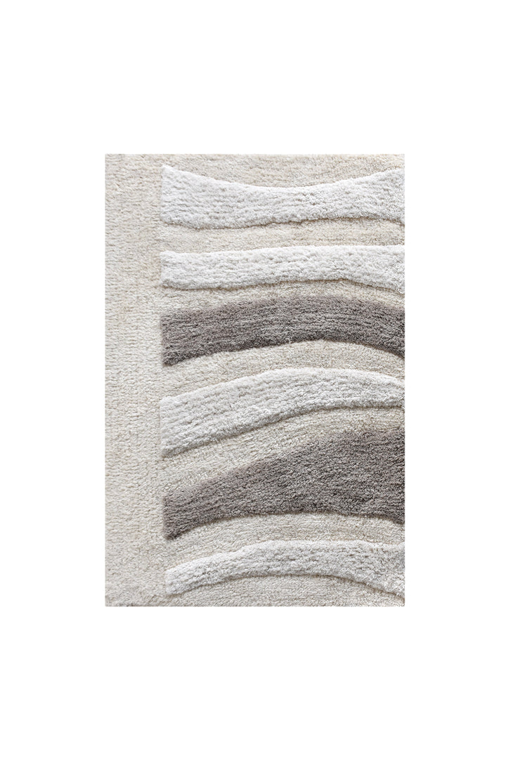 Silver Rill Cotton Bath Rug — Raised ivory and grey waves give this neutral bath rug movement and texture.