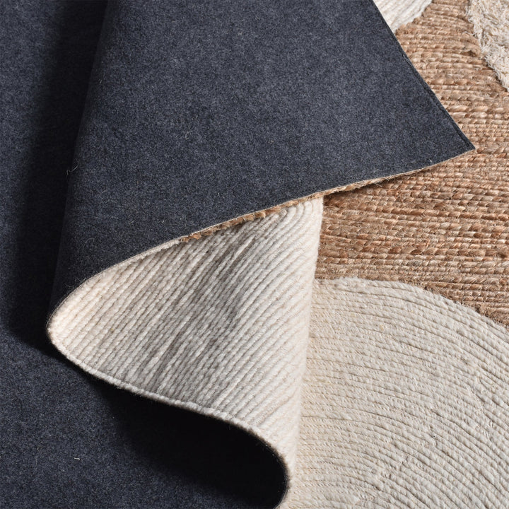 Boond handwoven wool, hemp and cotton rug with overlapping ivory and tan circles, in a bedroom