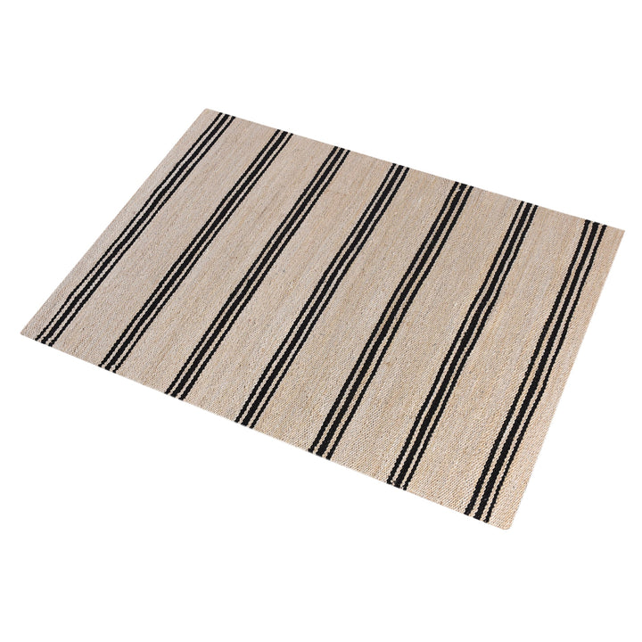 Khaat handwoven natural jute rug with black stripes, in a living room