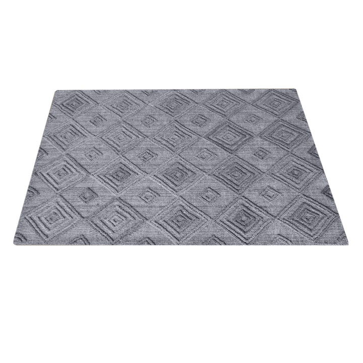 Jaali handwoven oatmeal wool rug with raised ivory diamond lattice, in a living room