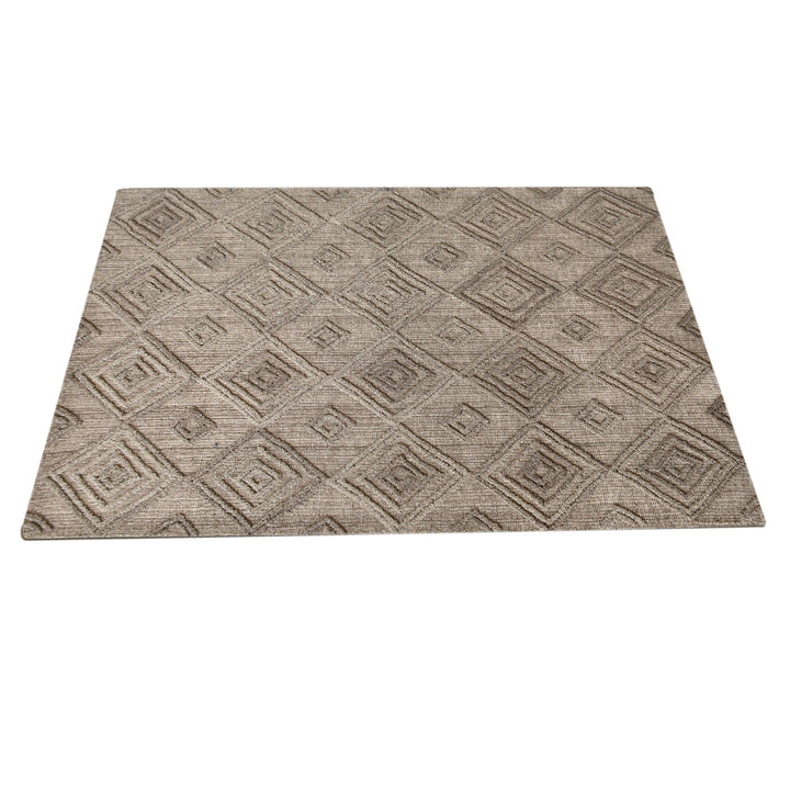 Jaali handwoven oatmeal wool rug with raised ivory diamond lattice, in a living room