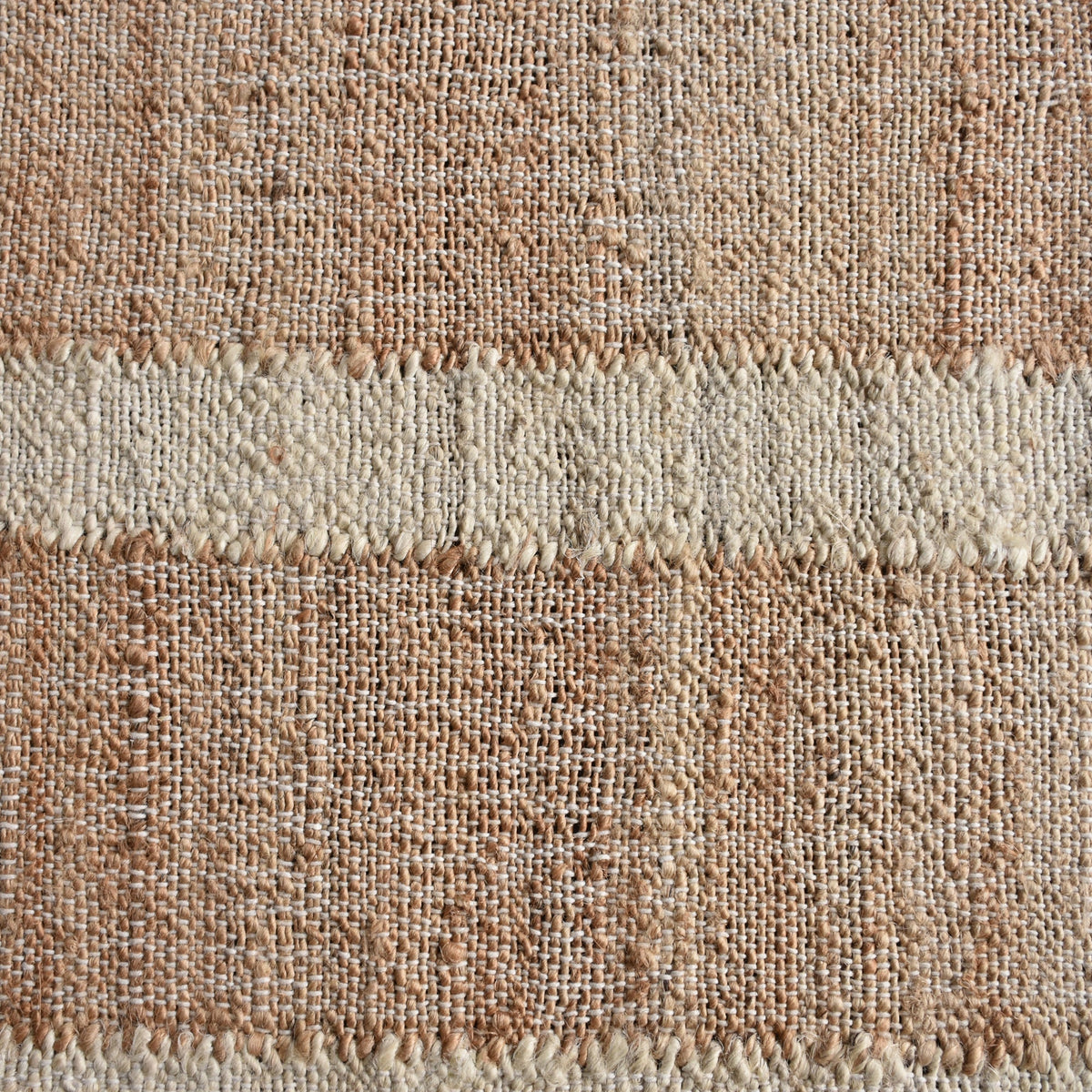 Diwar handwoven jute flatweave rug in natural, blush and ivory blocks, in a living room
