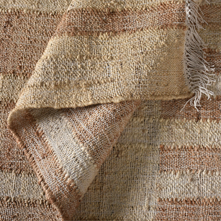 Diwar handwoven jute flatweave rug in natural, blush and ivory blocks, in a living room