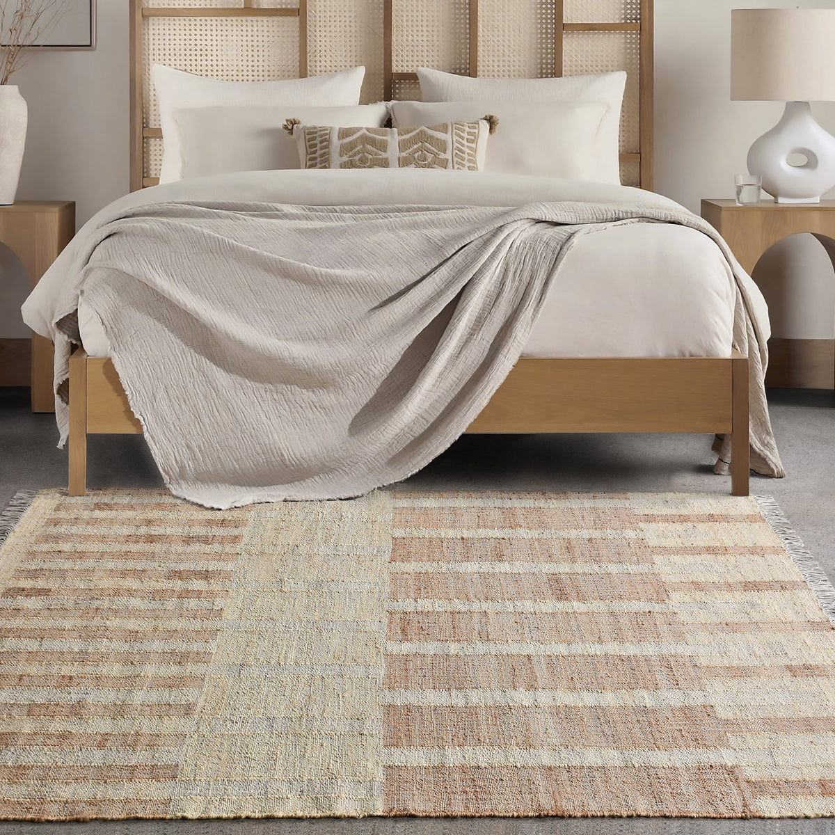 Diwar handwoven jute flatweave rug in natural, blush and ivory blocks, in a living room