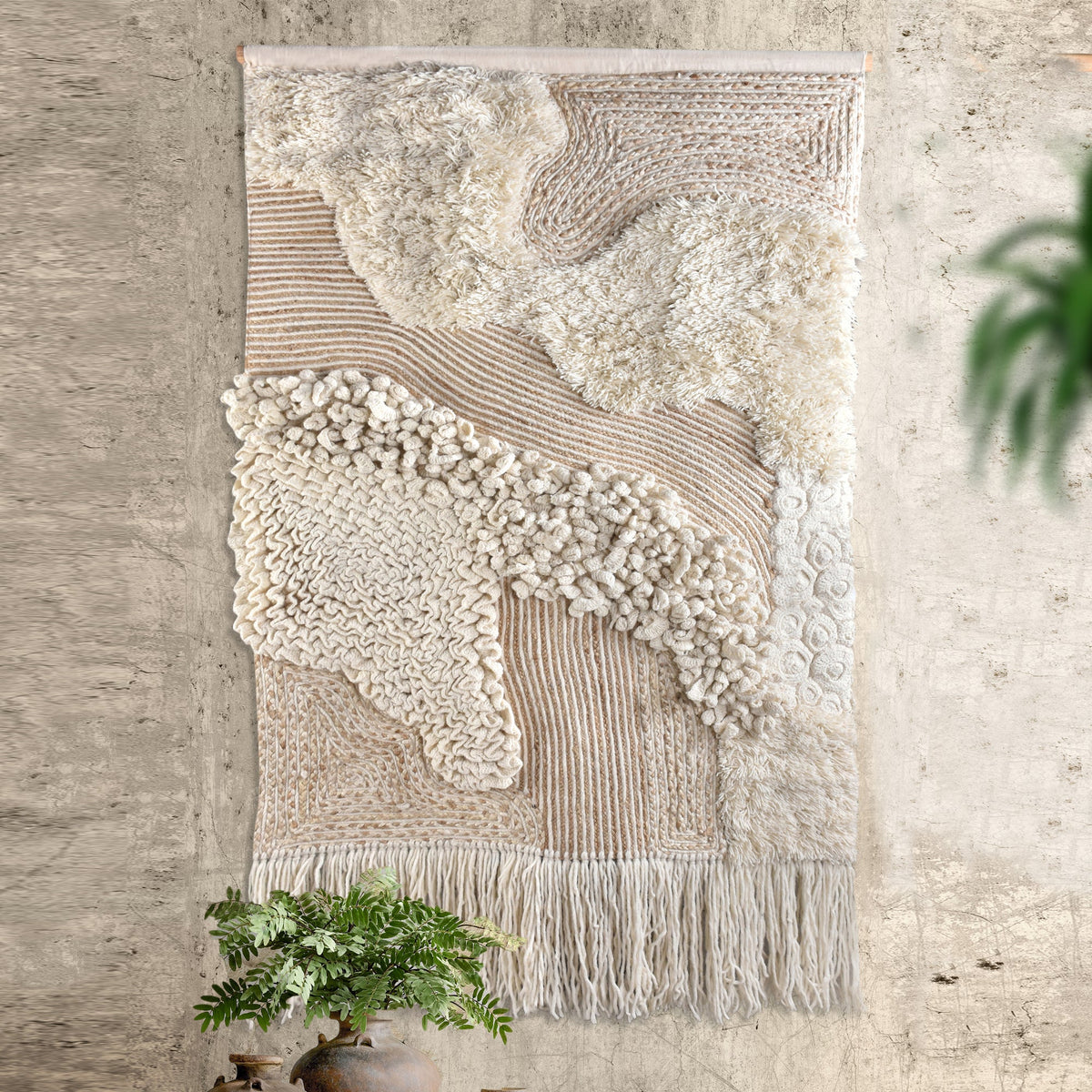 Cloudbank Textured Wool Wall Hanging — Raised ivory shapes and a fringed lower edge create a sculpted textile surface.