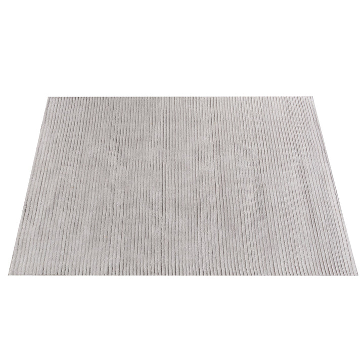 Megh handwoven NZ wool rug in light grey with wide ribbed vertical bands, in a living room
