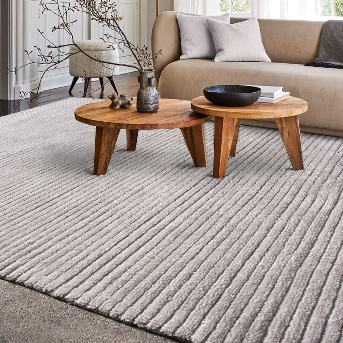 Megh handwoven NZ wool rug in light grey with wide ribbed vertical bands, in a living room
